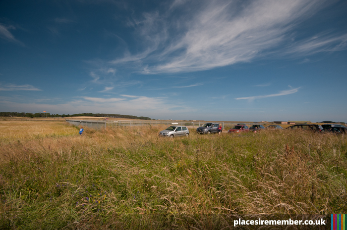 Cars gather at the west end of the runway at RAF Lossiemouth